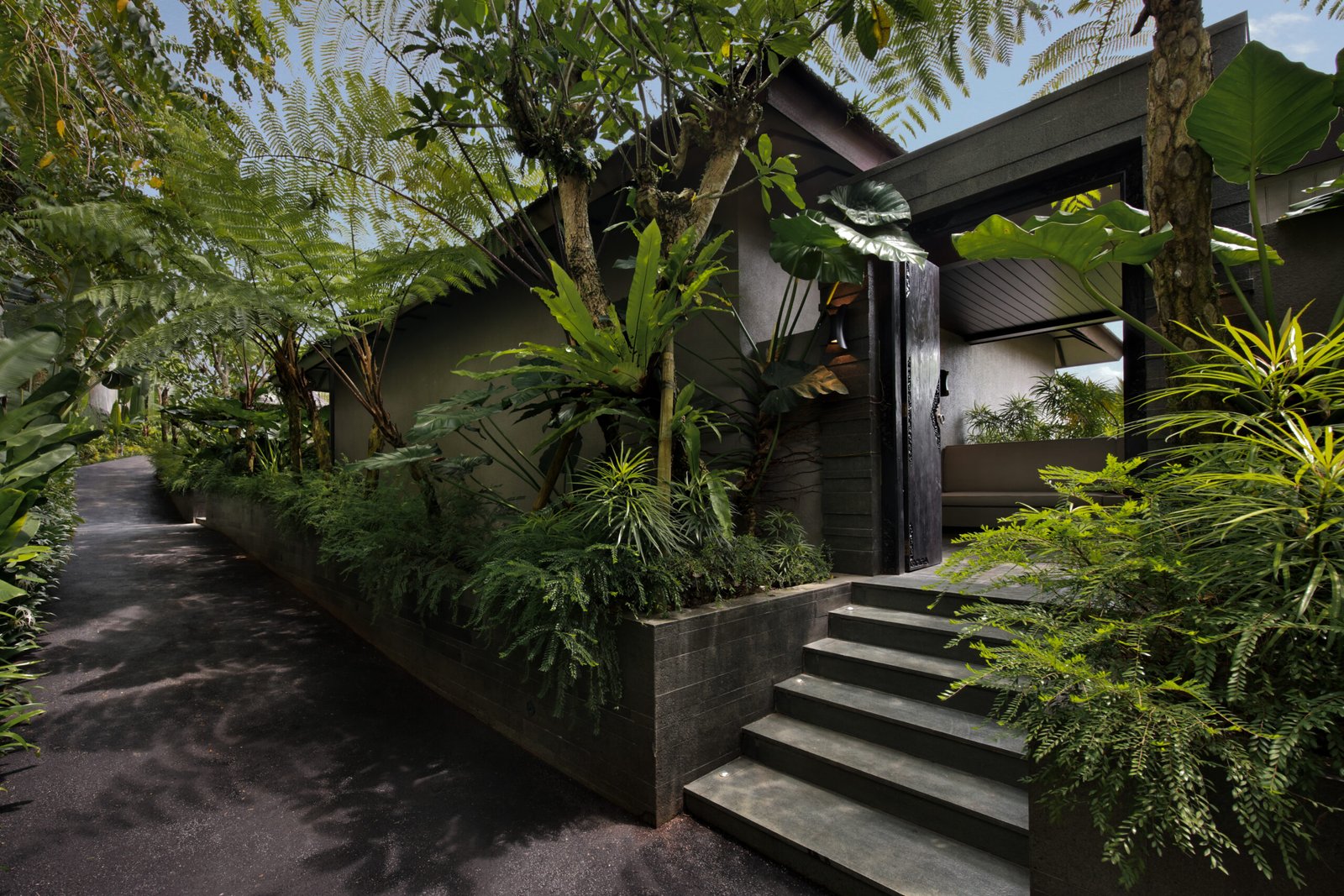 Tropical entrance to the SNEHA Balcony Room at Ayatara Villa Ubud Kintamani Bali – a boutique villa di Bali surrounded by greenery