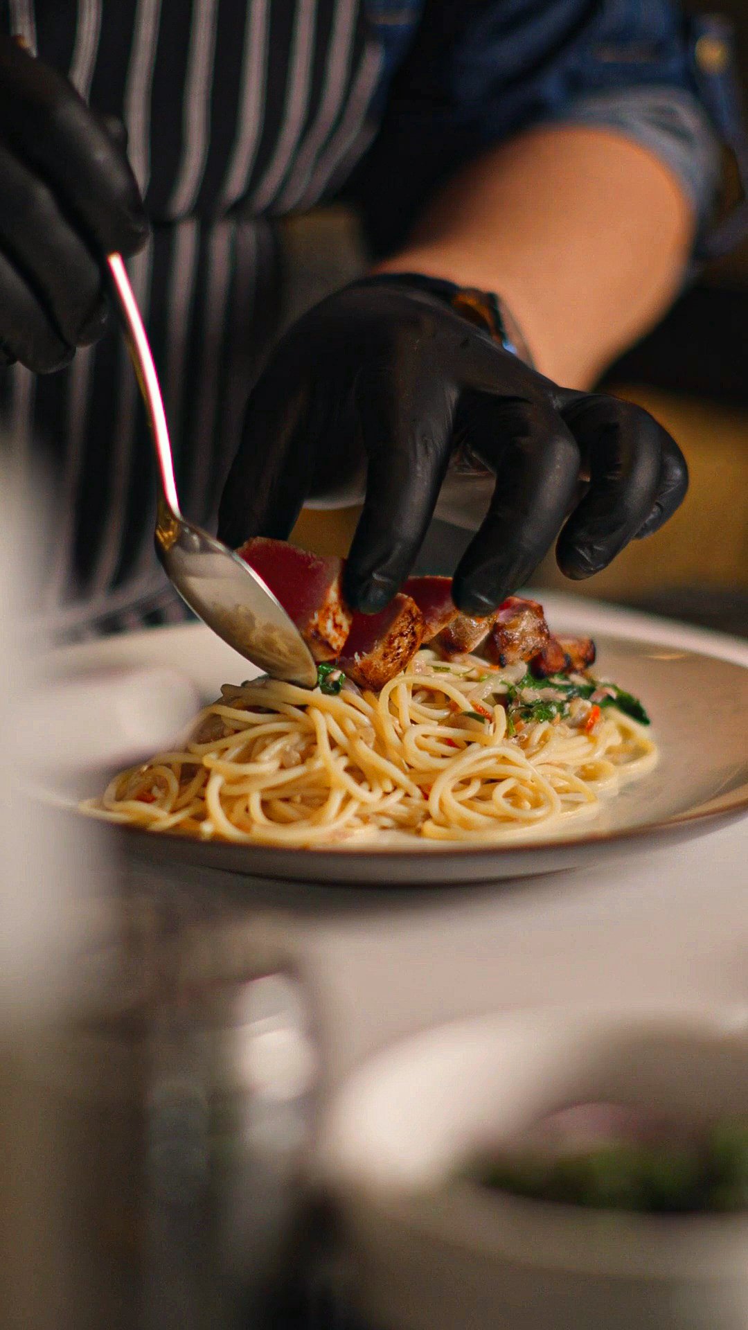 Chef plating a gourmet pasta dish at ON J Restaurant, a dining highlight at Ayatara Villa Ubud Kintamani Bali