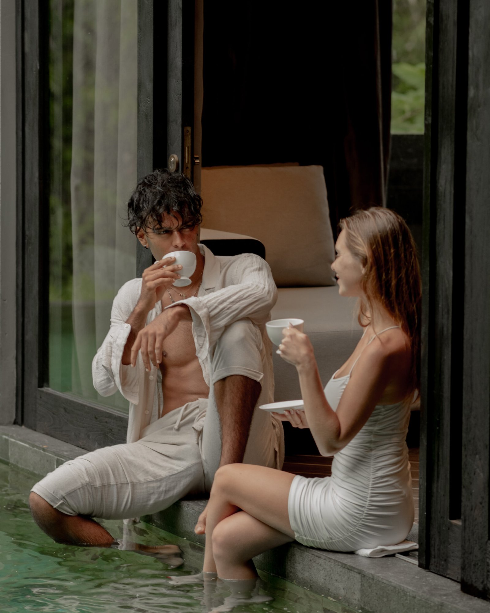 Couple enjoying a morning coffee at the balcony of Ayatara Villa, a perfect Bali villa for honeymooners